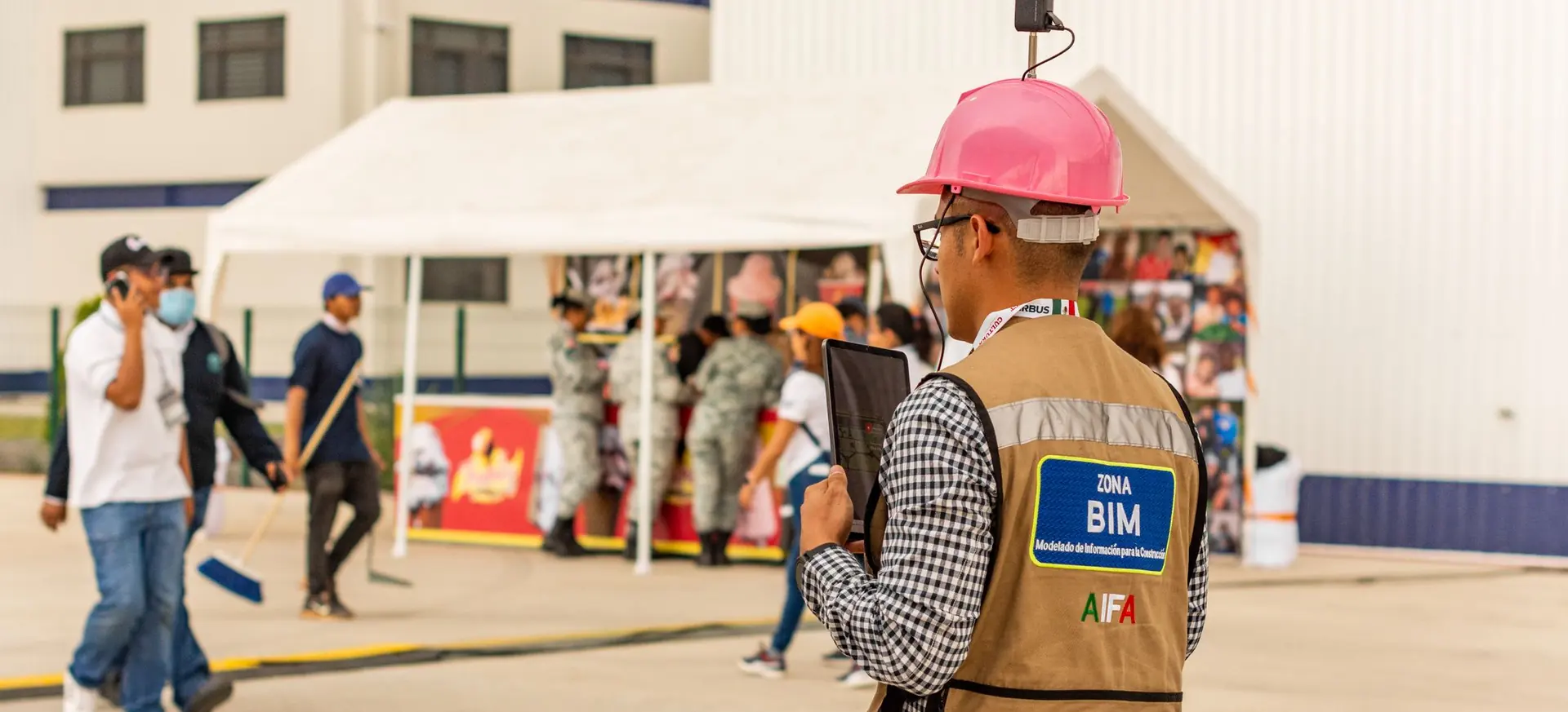 Construction inspector with a tablet and camera on a job site